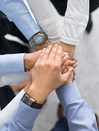 multiple hands in center for teamwork